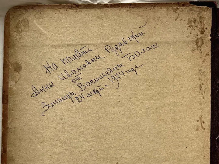 An open handwritten notebook, its first page inscribed in ink.